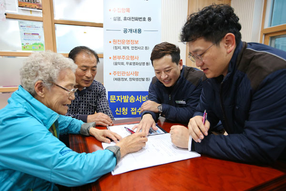 고리원자력본부 직원들이 부산시 기장군 장안읍 구기마을을 찾아 '고리본부 SMS알리미' 신청 접수를 받고 있다. (사진제공=고리원자력본부)
