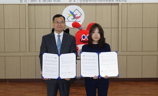 인천광역시 선거관리위원회 이유대 사무처장과 (주)코안스튜디오 문오경 대표가 협약 후 기념촬영하고 있다(사진= 인천선관위)