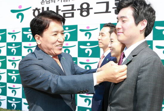 함영주 KEB하나은행장(사진 왼쪽)이 직원에게 새로운 CI배지를 달아 주고 있다. (사진=KEB하나은행)