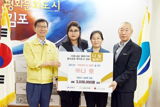 유영록 김포시장과 조연덕 김포복지재단 이사장(맨우측)이 (주)나로의 여성용품 1500팩을 기부받고 기념촬영하고 있다(사진= 김포시)