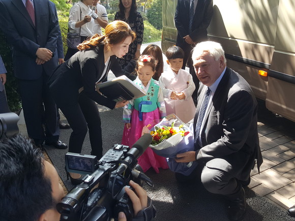 지난 8일 파주시청을 방문한 호주 안토니오 투움바 시장 일행이 버스에서 내려 화동으로부터 꽃다발을 선사받고 있다(사진= 김진부 기자)